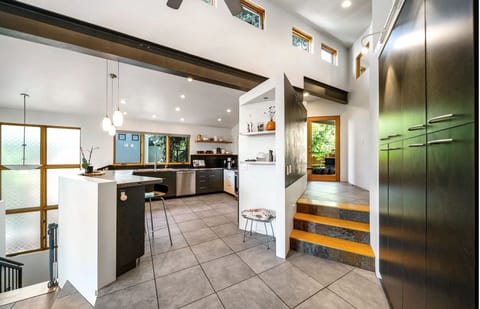 A space defined by contrast, blending organic calm with a sleek industrial edge.