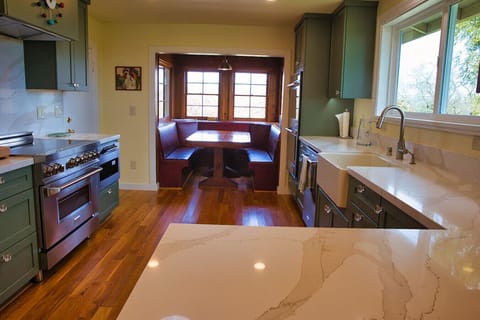 Find comfort in the kitchen with the booth like dining table and stunning modern appliences