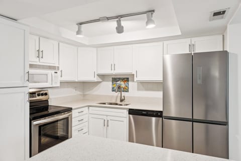 Fully equipped kitchen with stainless steel appliances.