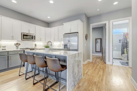 Welcome to this chic modern kitchen, perfect for your Nashville getaway! With ample counter space and stylish seating, it's ideal for brunch or celebrating with friends. Enjoy upscale living in this spacious rental designed for large groups in Music City.