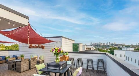 Discover your Downtown Nashville oasis! This stunning rooftop deck offers cozy seating, vibrant blooms, and breathtaking skyline views—perfect for stylish evenings with friends or a chic bachelorette party!