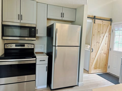 Fully Equipped Kitchen — Featuring sleek stainless steel appliances, this kitchen makes meal prep a breeze—whether you're whipping up a quick breakfast or crafting a gourmet dinner.