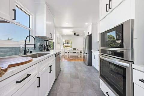 Beautiful brand new kitchen with all the amenities, pots & pans, drip coffee maker, blender, spices, filtered water dispenser, ice, and more.