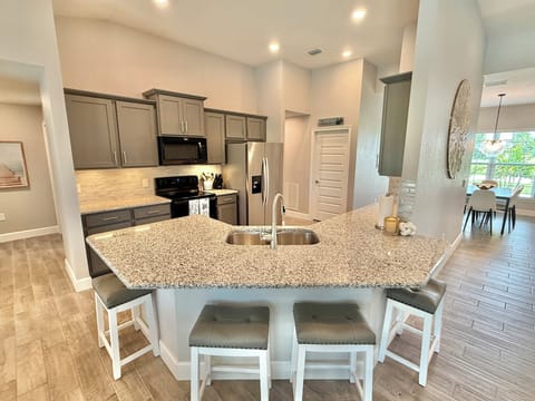 Large granite kitchen island seats (4) four.