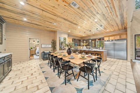 Large kitchen with custom table + counter seating. Commercial fridge, double sinks, dishwashers, trash cans, pantry and more!