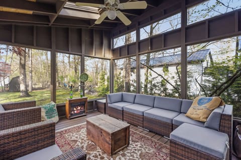 Screened-in porch with a comfy sofa and ample seating—perfect for relaxing outdoors.