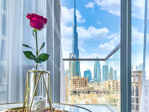View from the living room sofa: Burj Khalifa framed by golden morning light.