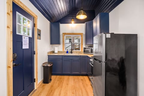 Sleek navy cabinetry, modern appliances, and bright lighting for delightful culinary adventures!
