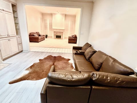 Living room with electronic couch that can recline, and Roku TV.