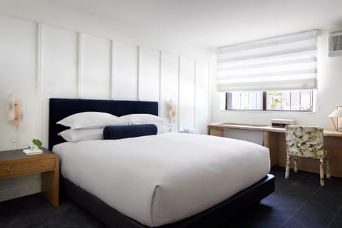 Unwind in crisp linens and a serene, modern retreat.