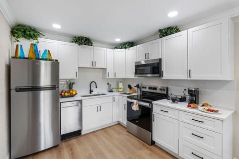 The layout is open and user-friendly, allowing you to move easily between the refrigerator, stove, and prep areas while staying connected to guests in the adjacent dining and living rooms.