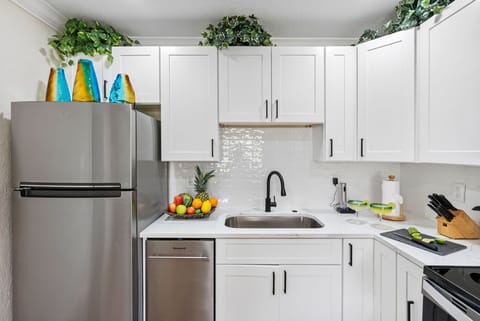 With its sleek cabinetry, polished countertops, and stainless steel appliances, the space offers both style and functionality.