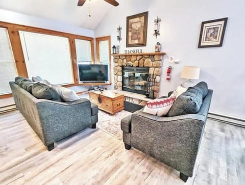 Spacious & cozy living room with a large TV and comfy vibes!