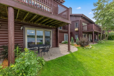 Ground-level patio with outdoor seating overlooking the lawn.