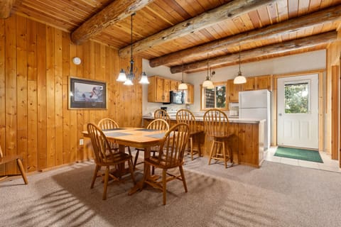Rustic dining nook with wood paneling and comfortable seating.