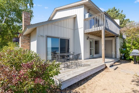 Charming exterior view of the property with a sandy path and lush landscaping.