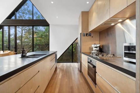 Modern luxury. Designer kitchen and dining space that opens to the deck for effortless entertaining.