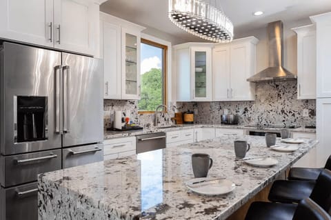 Cook in style in this sleek kitchen featuring quartz countertops, stainless steel appliances, and ample storage for a seamless culinary experience.