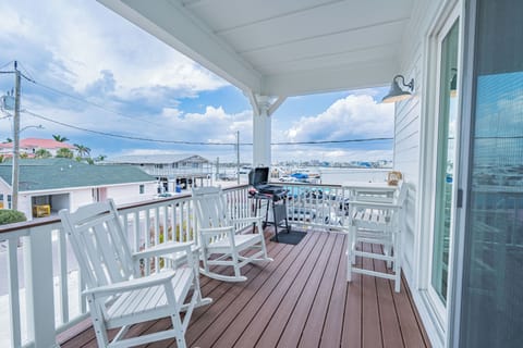 Cozy front porch with seating and a stunning view of the bay — perfect for morning coffee or evening sunsets.