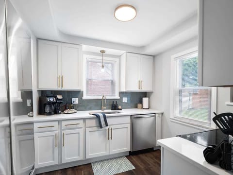 Whip up delicious meals in this modern kitchen featuring stainless steel appliances, brass finishes, and a fully stocked coffee station ☕. Bright, sleek, and ready for your stay! ✨