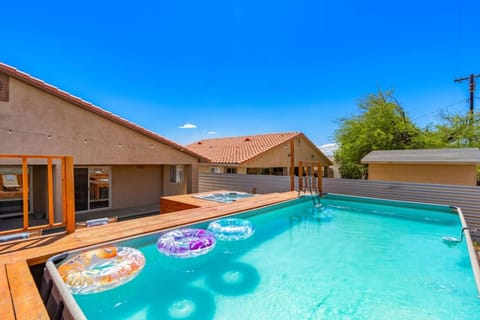Private backyard pool framed by warm wood decking, ideal for sunny afternoons & easy outdoor lounging.
