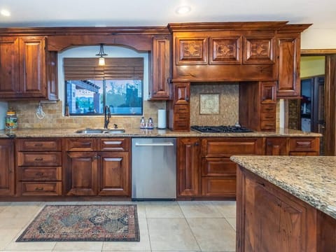 Kitchen overlooking Pool area, with 2nd Bathroom & Laundry off to right