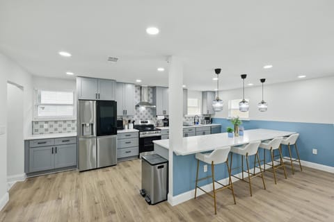 This dazzling kitchen is a culinary masterpiece waiting for you to step inside and work your magic with gleaming countertops, top-notch appliances, and an oversized kitchen island!