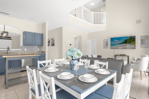 Elegant Dining Area With Seating For Six And Stylish Blue Accents