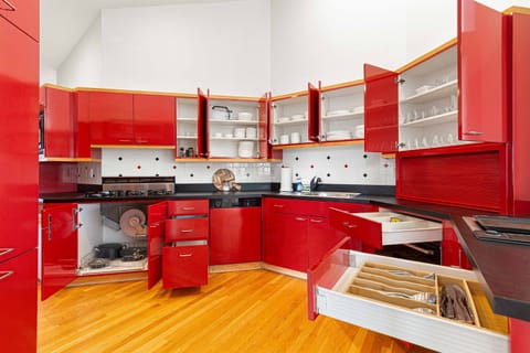 Dazzling red cabinets and sleek appliances await your culinary adventures!