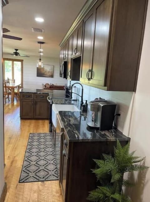 Granite countertops, a farmhouse sink, dishwasher, modern stove.