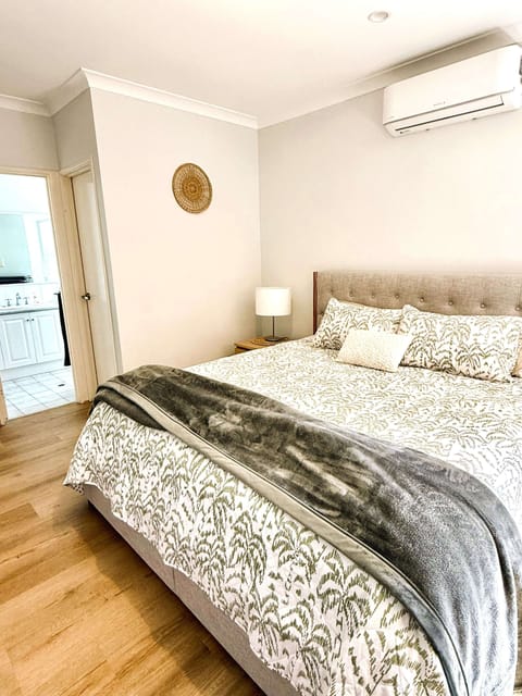 Drift off to sleep in this inviting bedroom, offering a comfortable bed and a soothing lampshade for your ultimate relaxation.