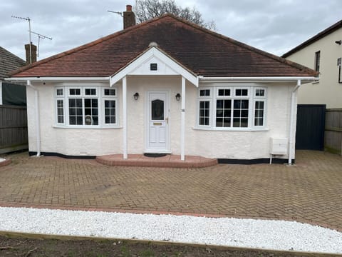 Front of the property, with spacious driveway for parking.