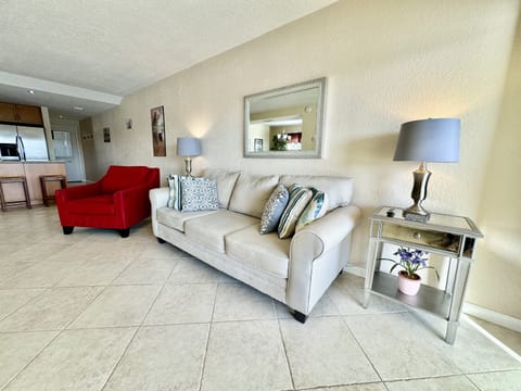 The cozy living room is furnished with a plush couch and an additional soft, cushioned sofa, offering ample seating for relaxing after a day of exploring Treasure Island.
