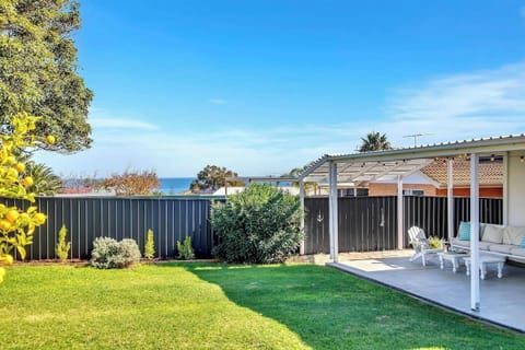 From the backyard, enjoy glimpses of the ocean over a glass of wine.
