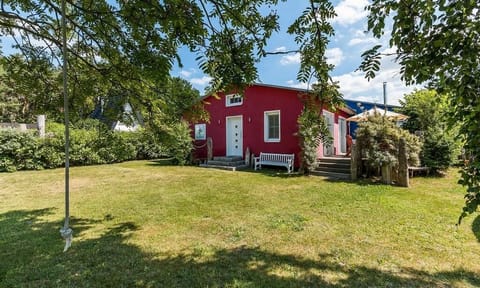 Exterior view of a red house with garden