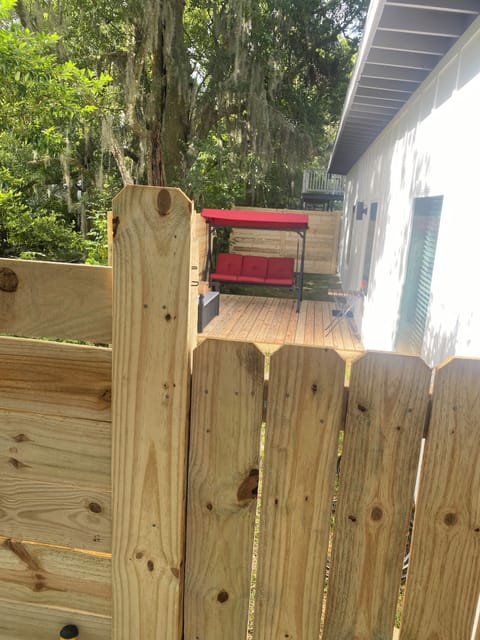Side deck, partially fenced, privacy gate at entrance. 