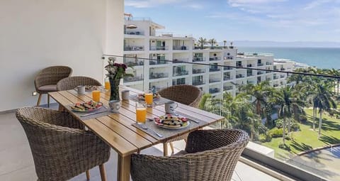 Private balcony w/ woven seating & table, perfect for coffee while enjoying open views & fresh air