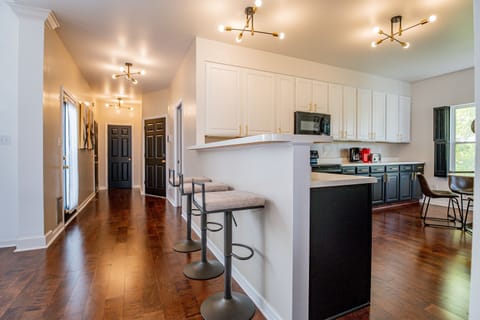 Pull up a stool and join the conversation - this bar area bridges the kitchen and living room, making it the perfect spot to sip, snack, or keep the cook company.