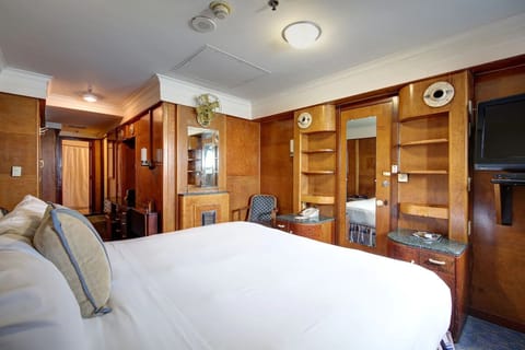 Recharge in a warm wood-finished room with thoughtful storage.