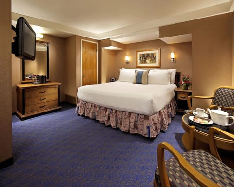 Sink into plush comfort in this inviting, warmly lit bedroom.