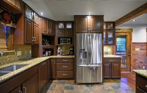 This kitchen has everything you need, from stainless steel appliances to ample space for family meals.