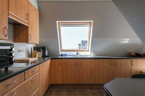 Warm kitchen and dining area with natural light and coastal charm.
