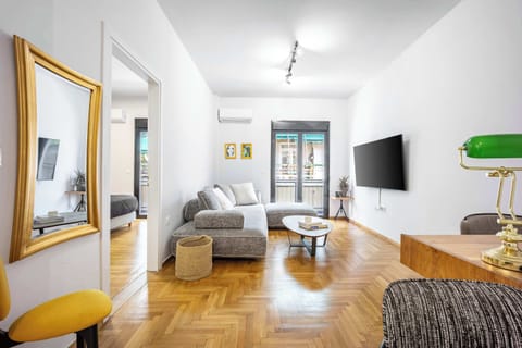 Spacious and inviting living room with a comfy couch—perfect for unwinding after exploring Athens.