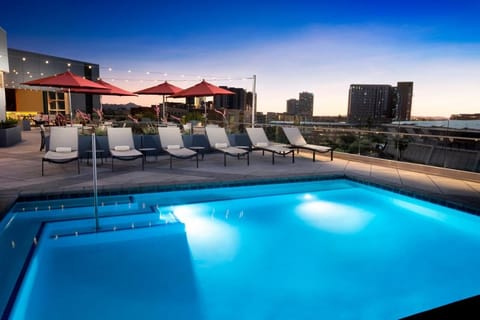 Slip into twilight waters with skyline-lit rooftop vibes.