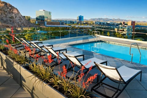 Soak up sunshine beside the rooftop pool and mountains.