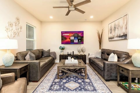 Living room with leather couches(one turns into queen bed) smart 65 inches TV