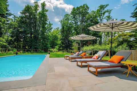 Saltwater pool with lounge chairs and bluestone patio.