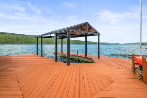 Expansive lakefront deck with seating, a canoe, and stunning water views—your private Finger Lakes retreat. 🚣‍♀️🌊☀️