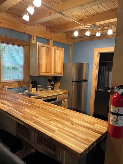 Butcher block bar seating in kitchen.