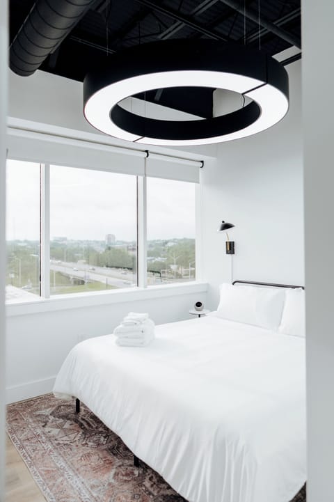 A cozy bed bathed in bright, natural light